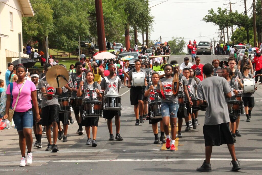 Participants walk in Austin’s annual Juneteenth parade through historic East Austin.