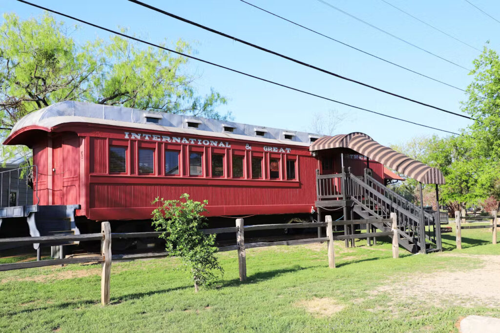 A restored train car serves as guest lodging at The Antlers Inn in Kingsland, Texas.