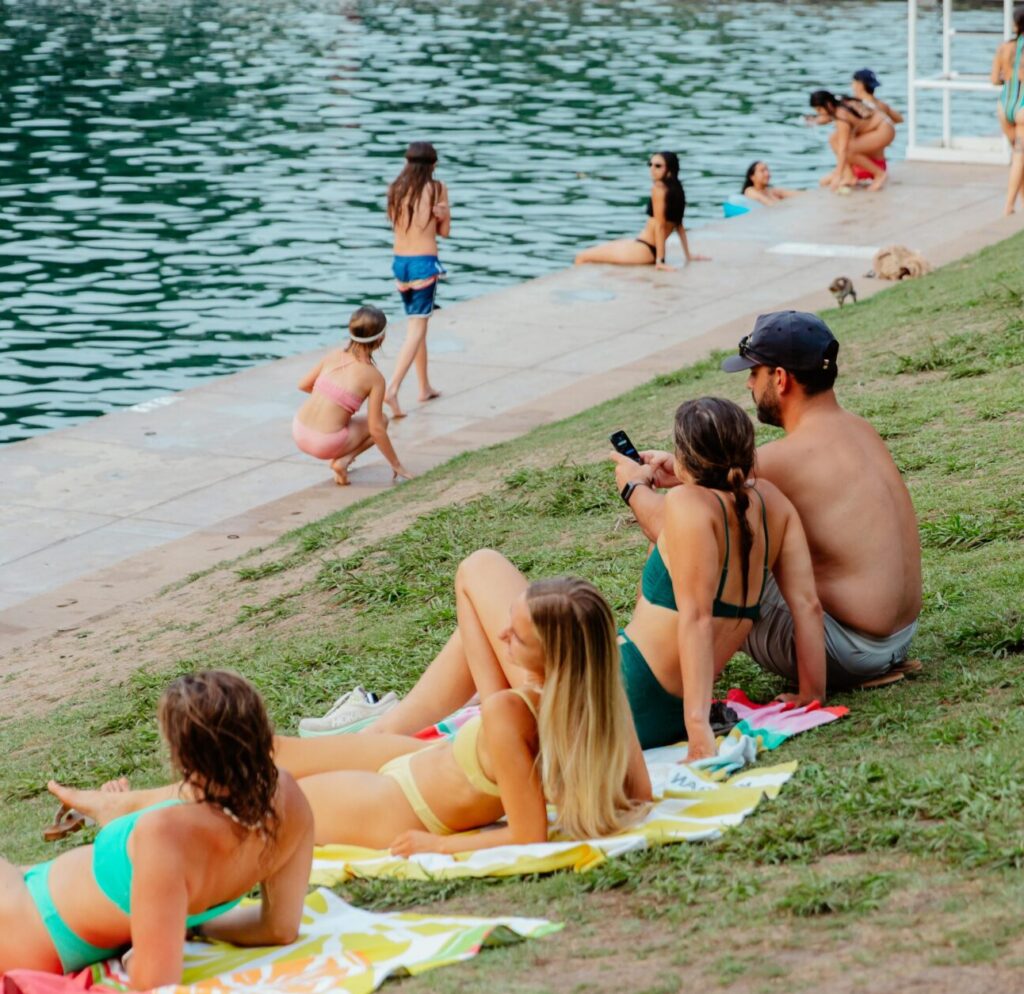 Locals sitting on the lawn at Barton Springs
