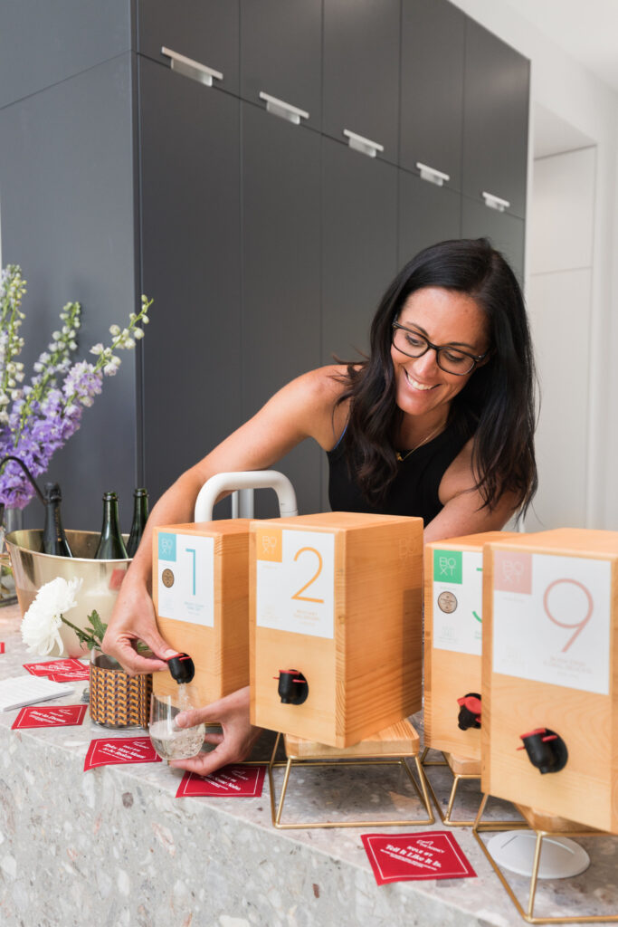 Sarah Puil at 2712 Maria Anna Open House with The Agency Austin Pouring BOXT Wine