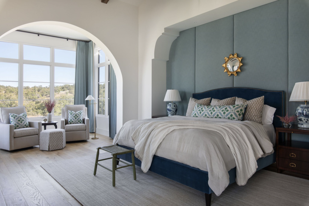 large bedroom with expansive windows elegant shades of blue