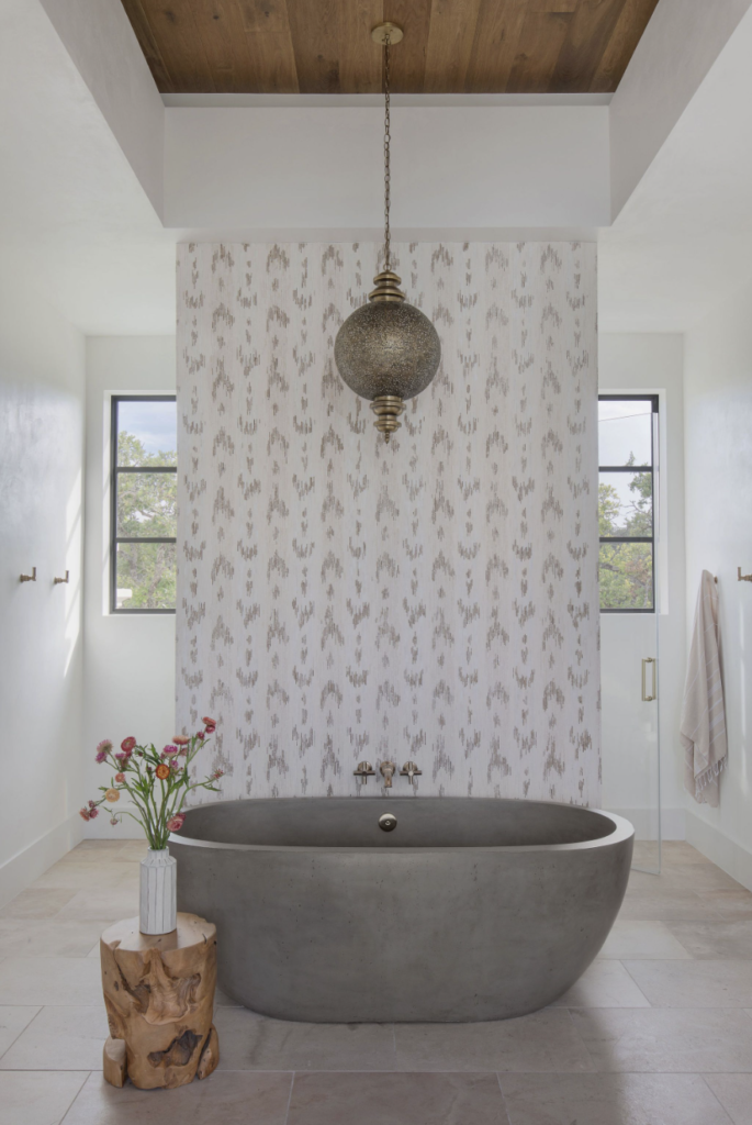 Bathroom with stone tub and ornate wallpaper