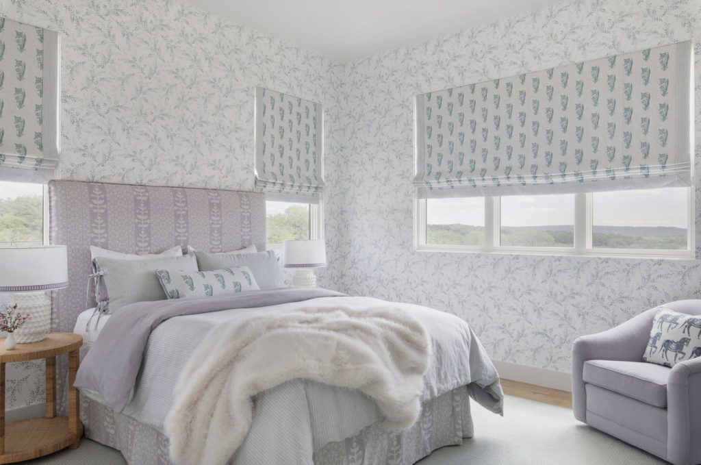 pretty bedroom with dainty wallpaper in Texas Hill Country home
