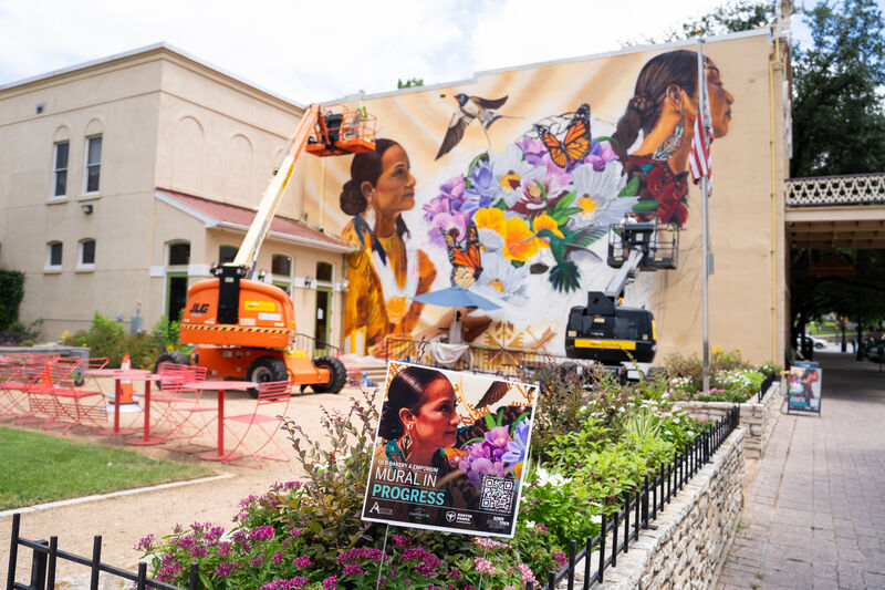 Mural being painted on a building