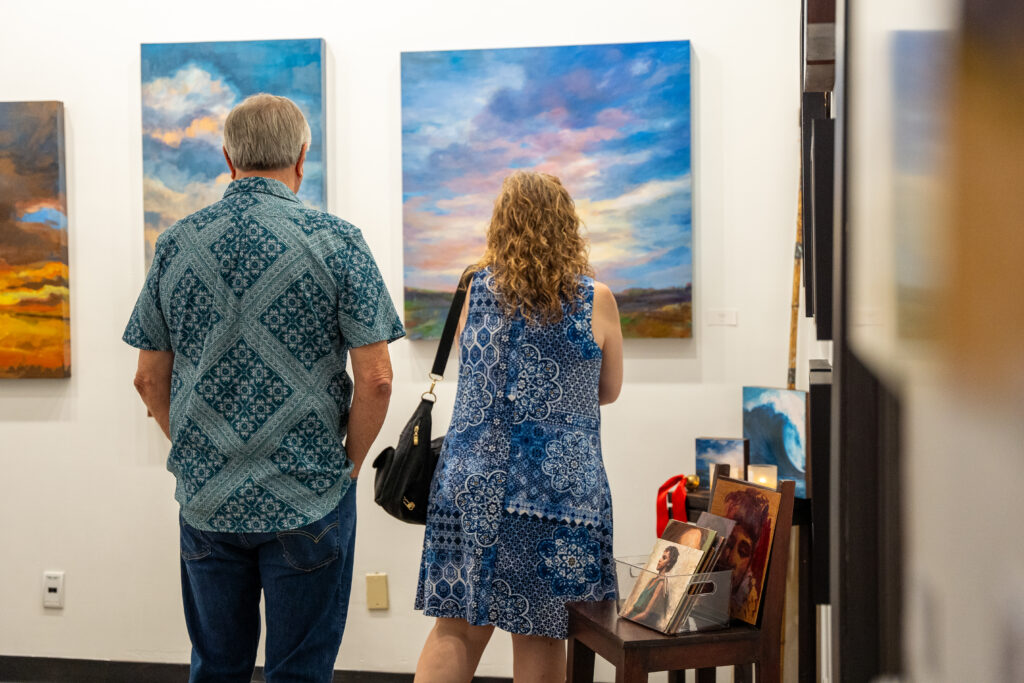 Patrons viewing works by Karen Maness. (Photo by Sabrina Macias)