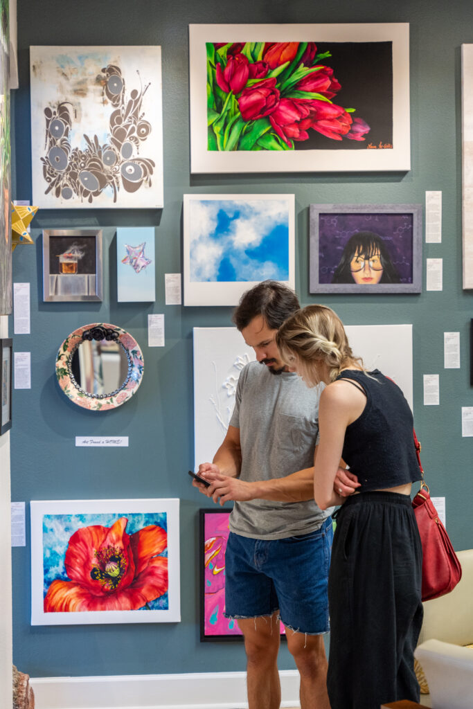 Guests viewing art on display during an open house. (Photo by Sabrina Macias)