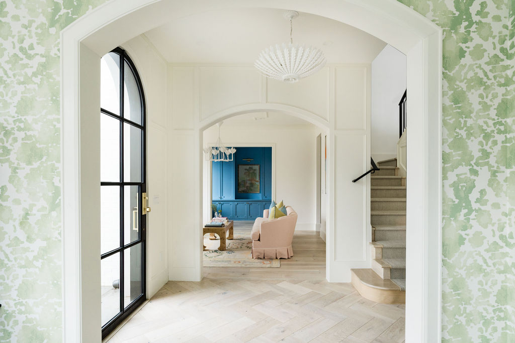 Front Door View with Family Room and Colorful green wallpaper