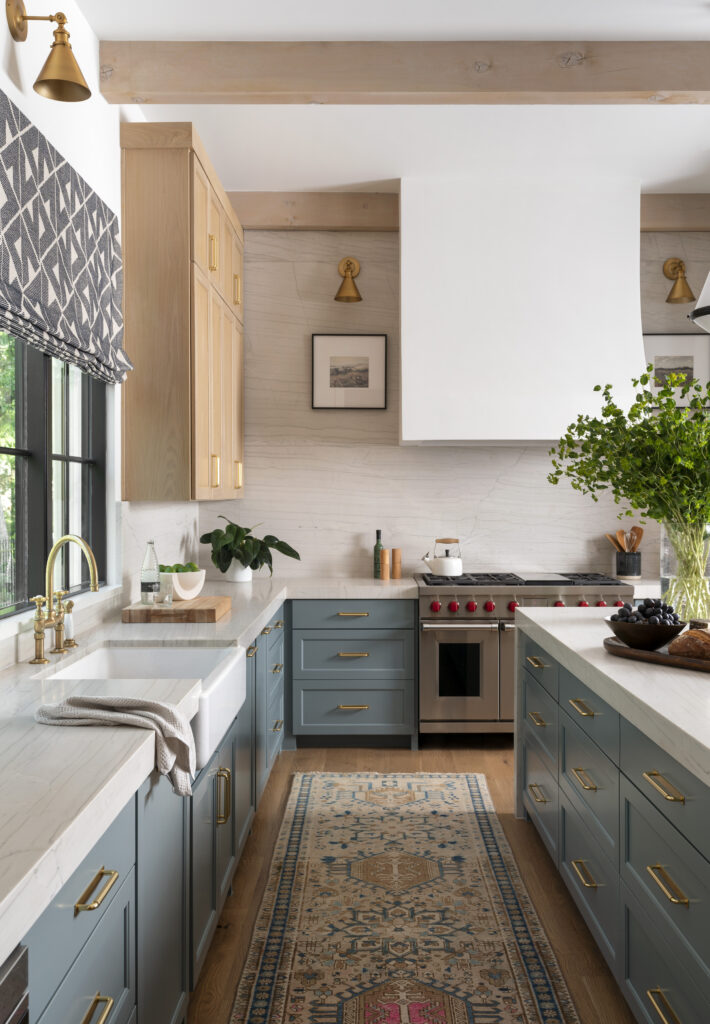 Kitchen with pale blue cabinets and white marble countertops.