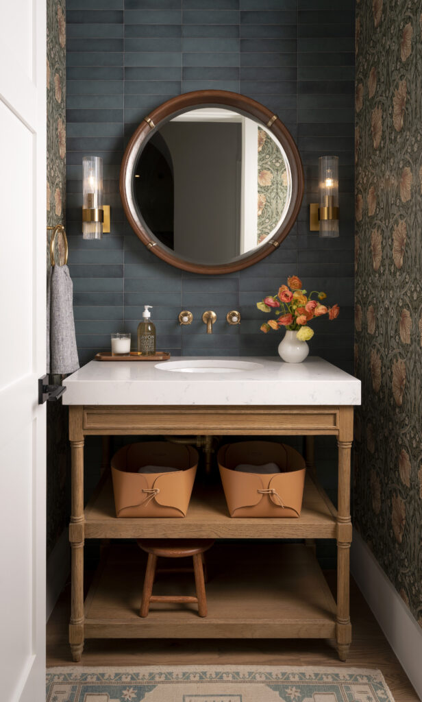 Powder Room feautring blue tile and vintage wallpaper on the accent walls.