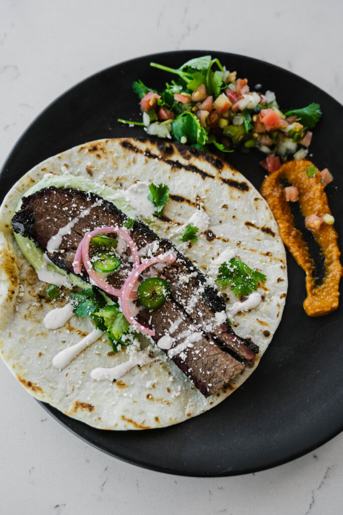 Black Gold's New Norteno Brisket Taco served with pico de gallo and salsa roja on the side. (Photo by Randi Reding)