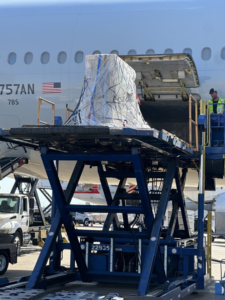 Blanton crate is loaded onto airplane