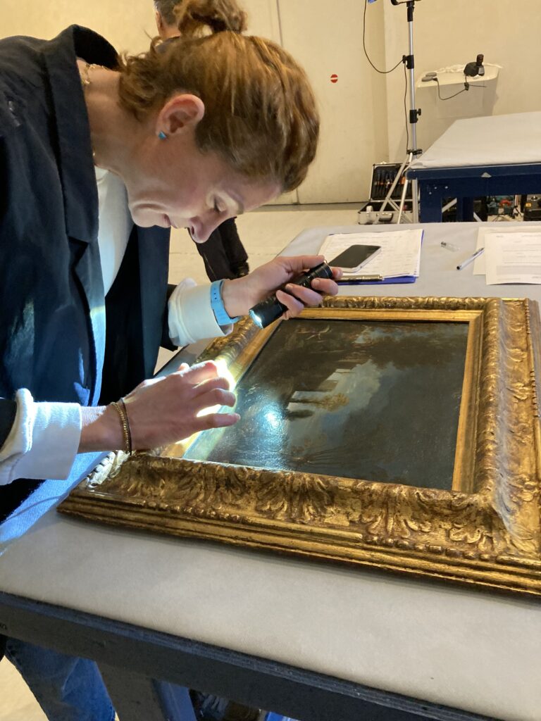 Conservator examining Guercino_s Landscape