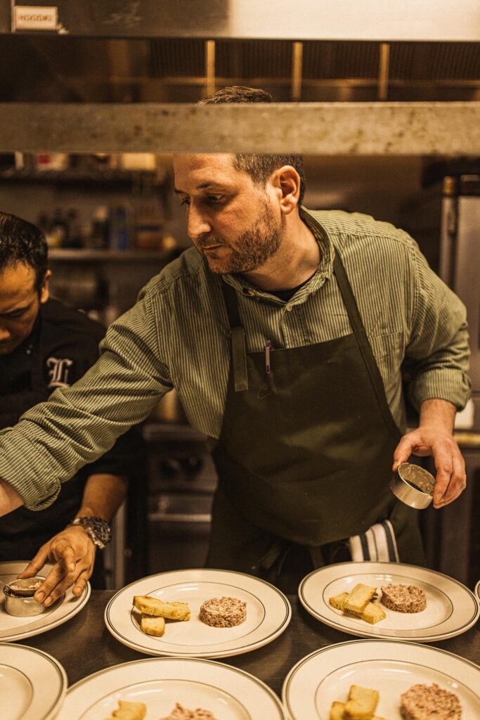 Chef Louis Ciola III in the kitchen at Cousin Louie’s, the latest concept from Tc4 & Co., featuring family recipes and Italian-American classics. (Photo by Whitney Runyon)