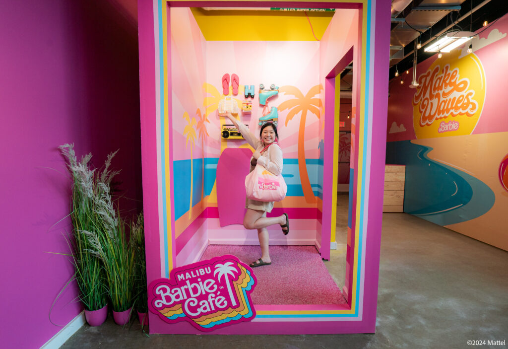A guest poses inside the life-size Barbie Box at the Malibu Barbie Café pop-up in Houston. (Photo courtesy of Bucket Listers)