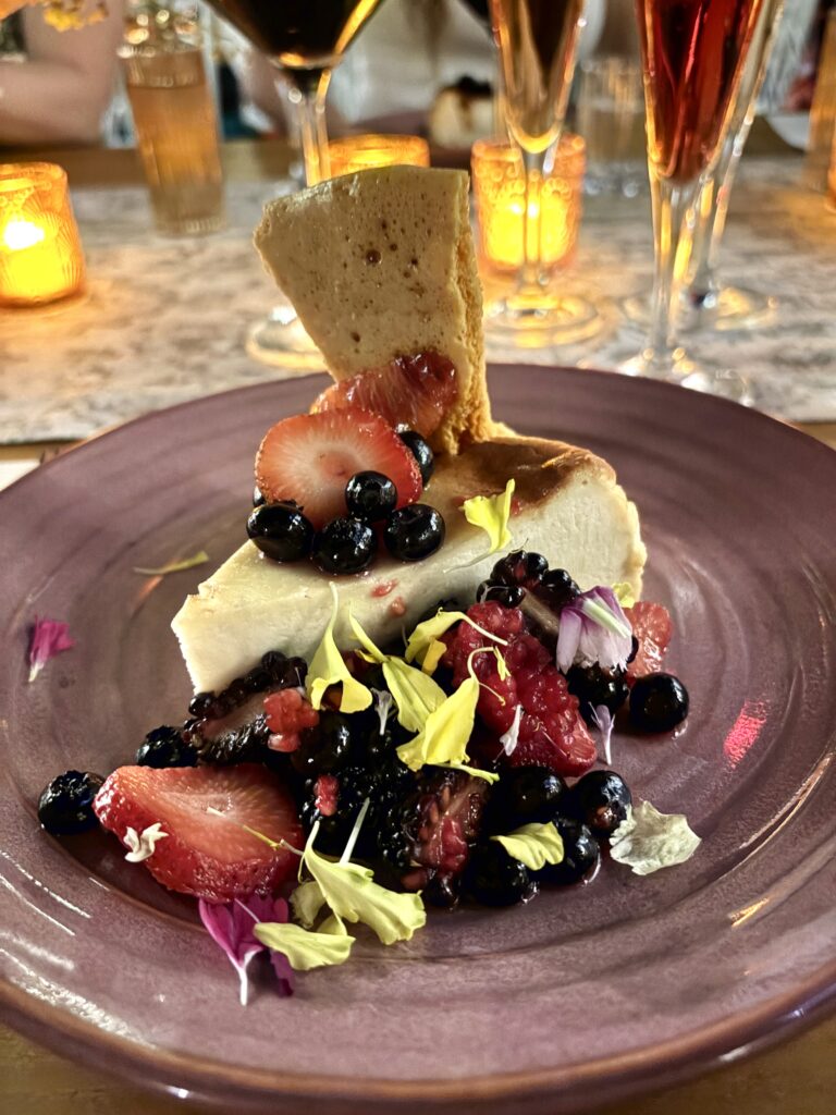 Honey cheesecake with honeycomb, blood orange, Alma Finca orange liqueur flambé, and berry salsa is served during the Viva Abejas dinner at the Four Seasons Hotel in Austin. (Photo by Christina Garcia)