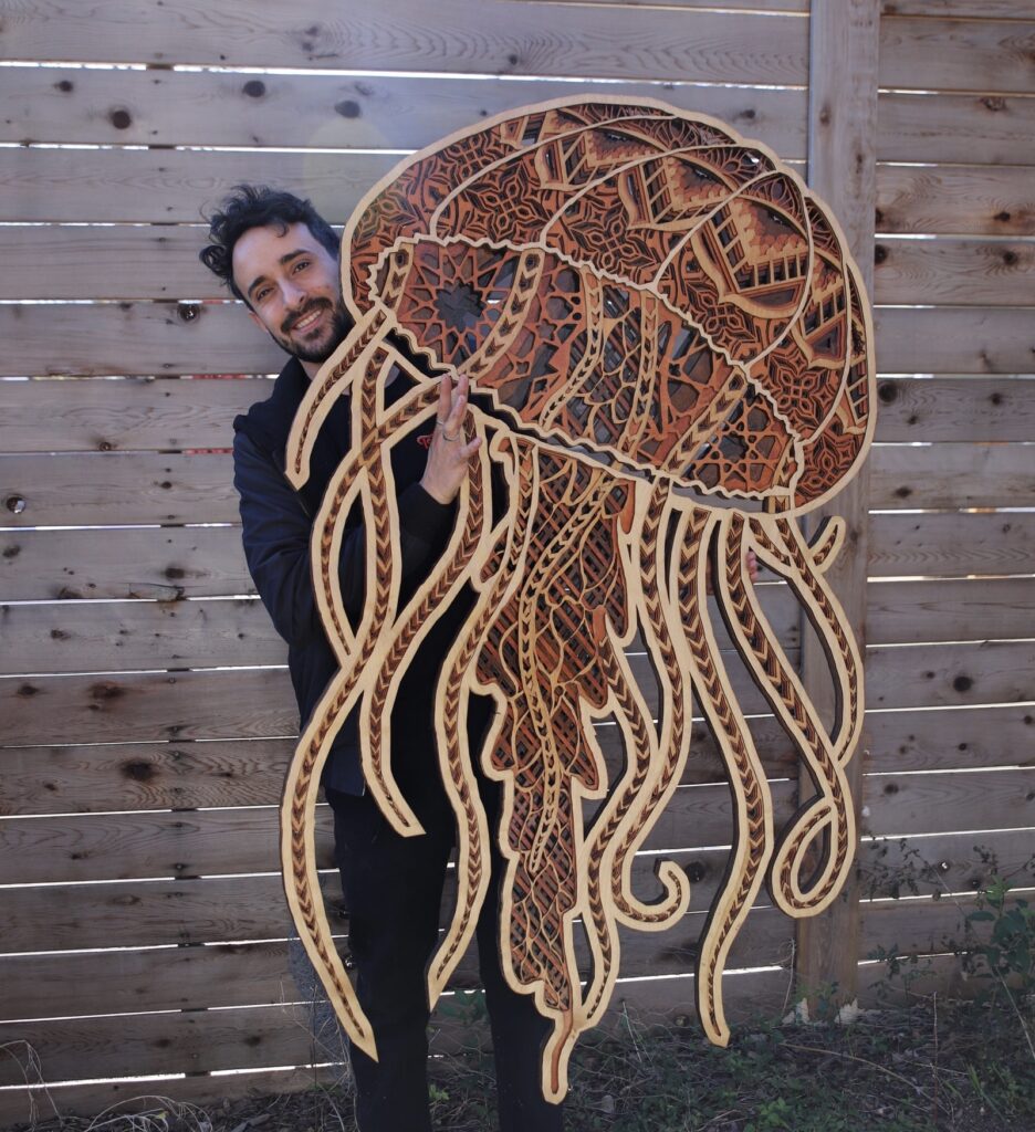 A custom woodwork piece by Felipe Gomez depicts a jellyfish composed of layered geometric designs.