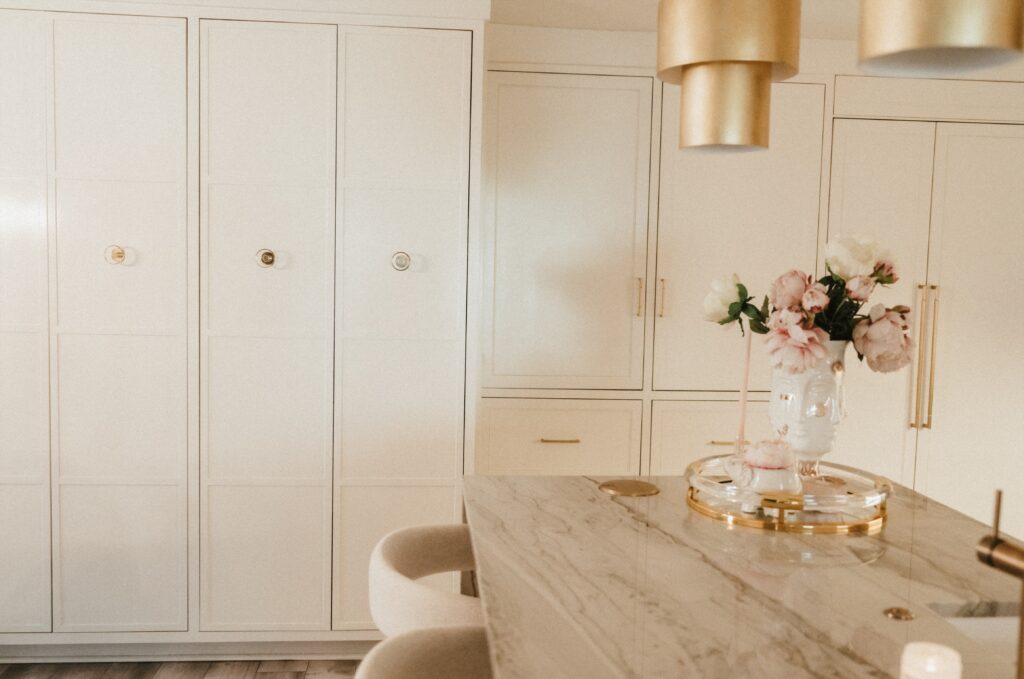 The kitchen showcases a waterfall island, along with custom cabinetry and appliances. (Photo Lemon Woman Photography)