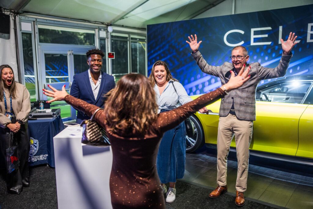 A guest celebrates after winning a giveaway for a COTA on-the-track experience at the ATX Open Players Party. (Photo courtesy of ATX Open)