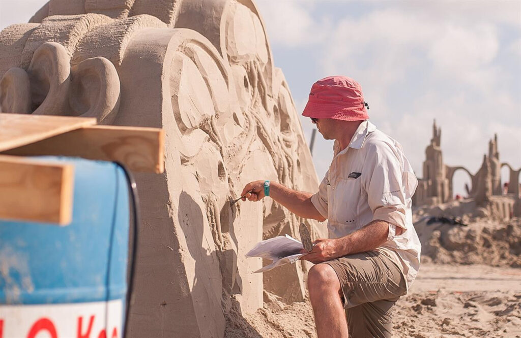 Artists makes large scale sand art at Texas Sand Fest.