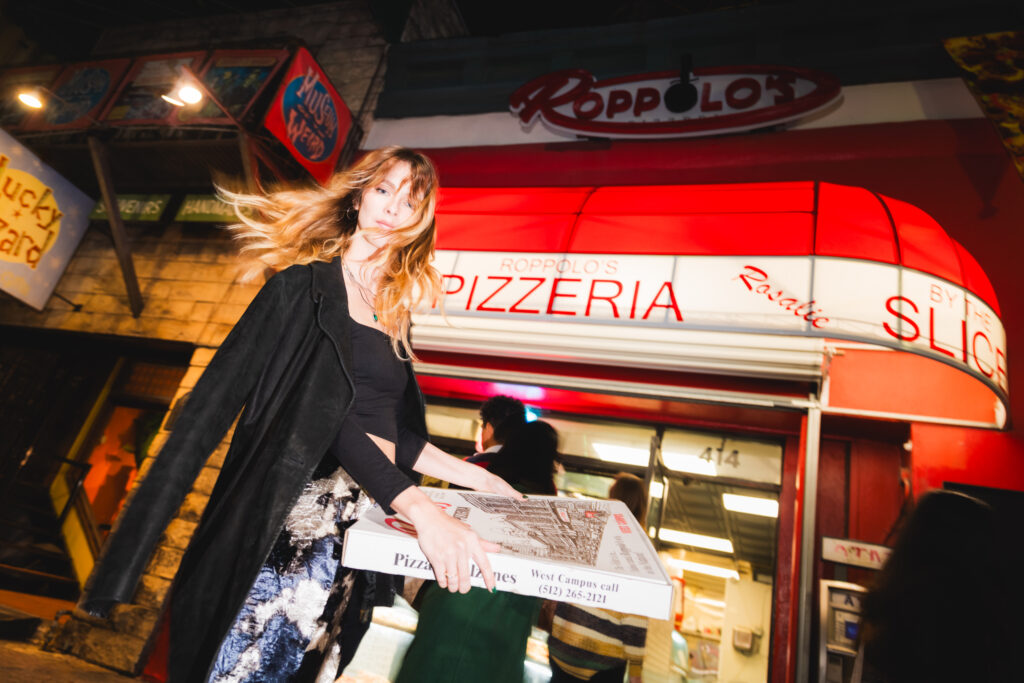 Tess Davis poses outside Roppolo’s Pizzeria on West Sixth Street. (Photo by Ismael Quintanilla III)