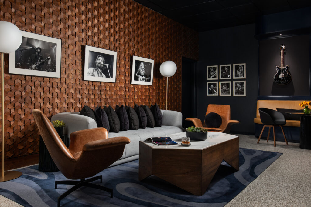 The Green Room at Austin PBS, redesigned by Britt Design Group, features lounge seating, a custom record console, and guitars on display in tribute to Austin’s music culture.