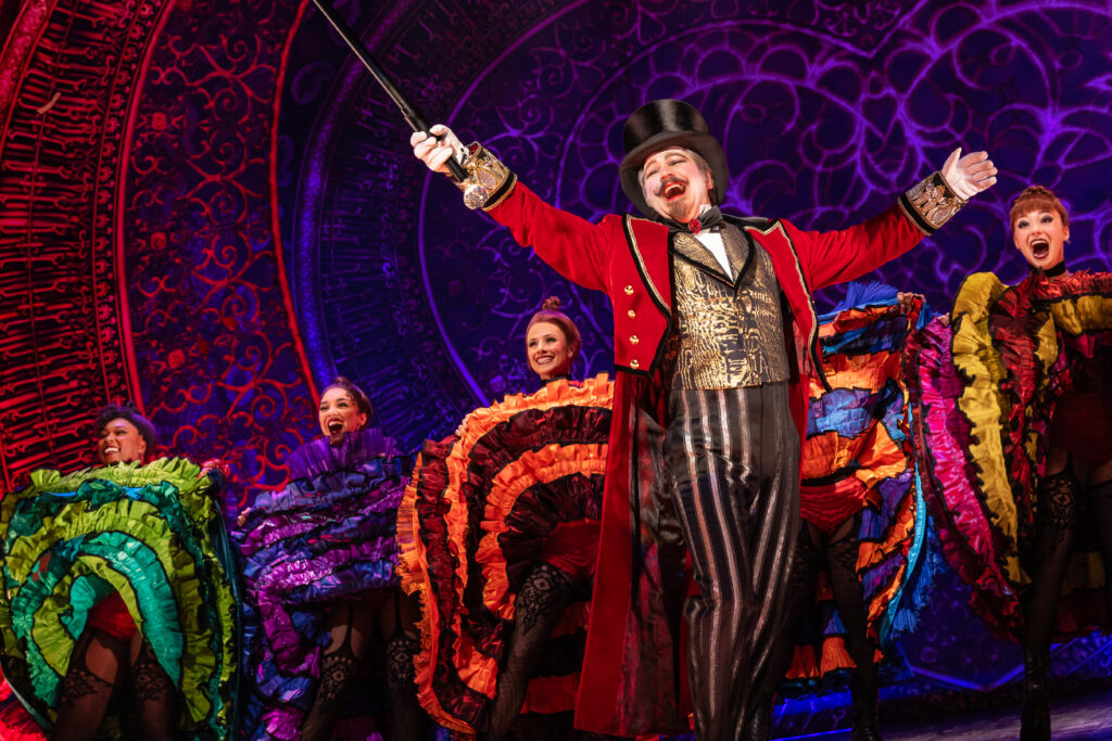 Robert Petkoff as Harold Zidler and the cast of the North American tour of "Moulin Rouge! The Musical." (Photo by Matthew Murphy and Evan Zimmerman for MurphyMade)