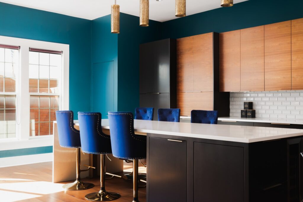 Kitchen with modern updates, blue accent wall and lots of natural light. (Photo courtesy of Moreland Properties)