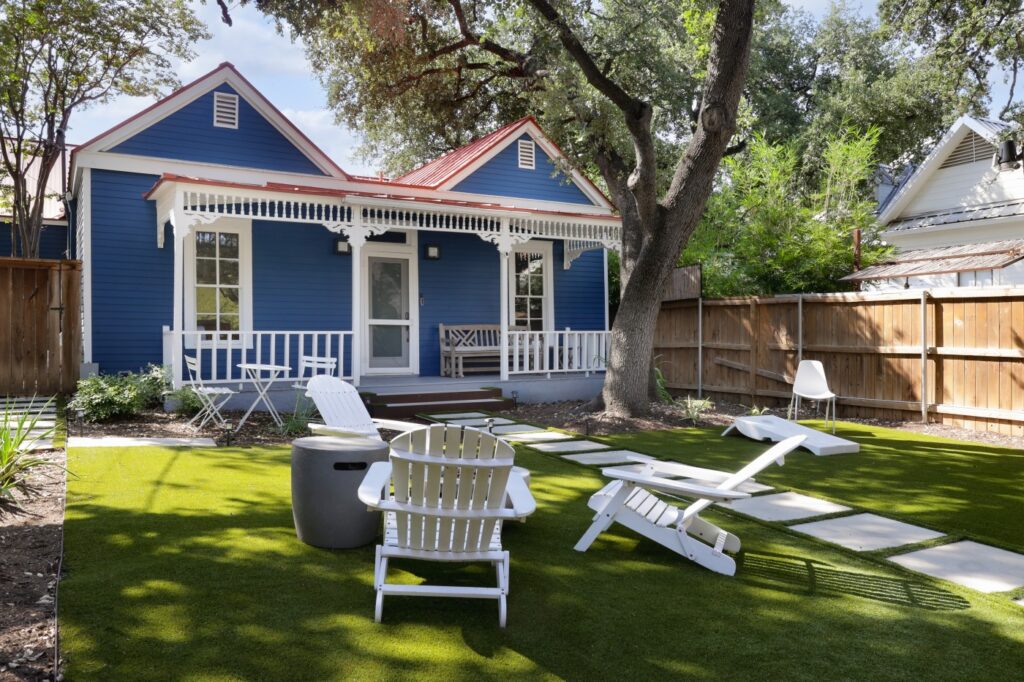 Blue cottage with white trim and large front porch. (Photo courtesy of Moreland Properties)