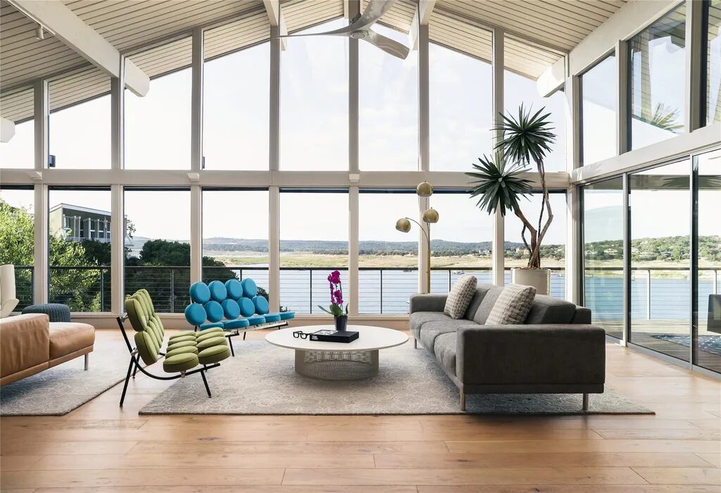 This Austin home has a view of the lake from the living room through it's floor to ceiling windows.