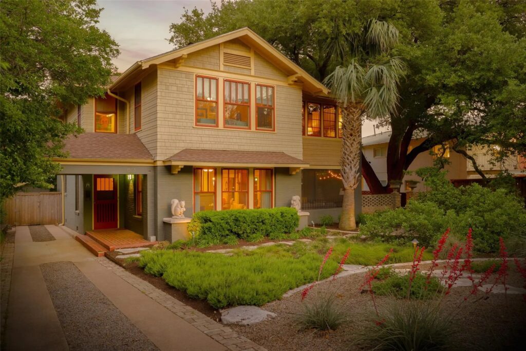 Austin home has sage green exterior and a well manicured lawn.