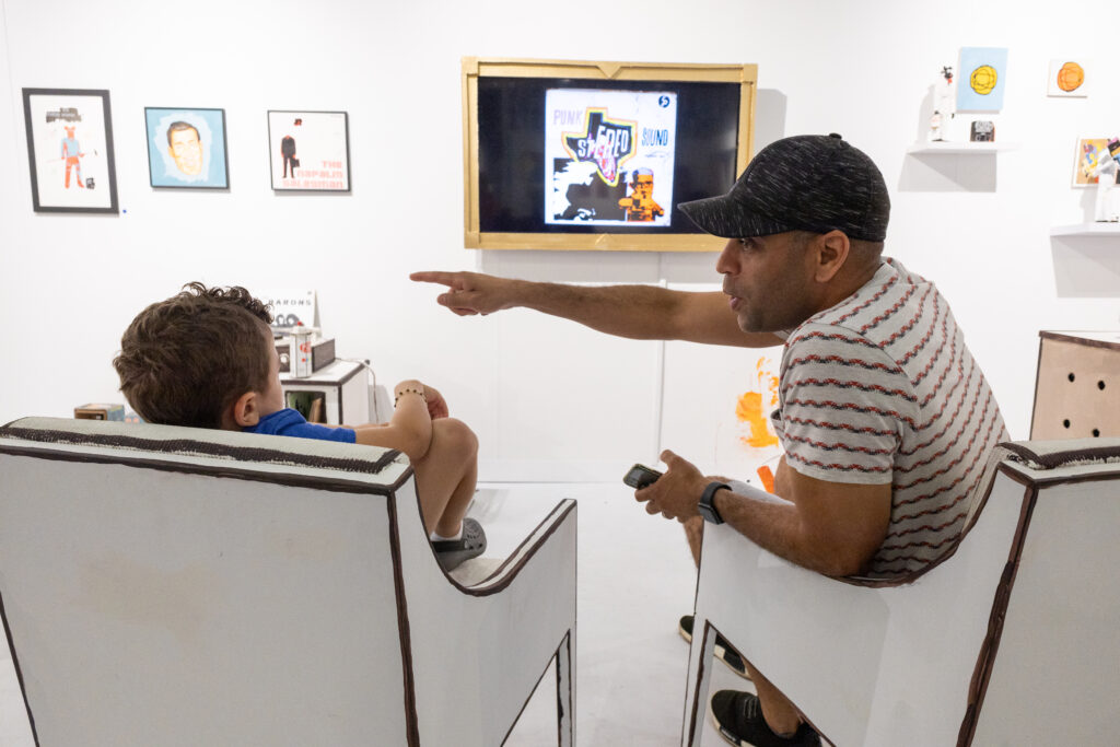 Visitors relax in one of the artist-designed lounge spaces. (Photo courtesy of Affordable Art Fair)