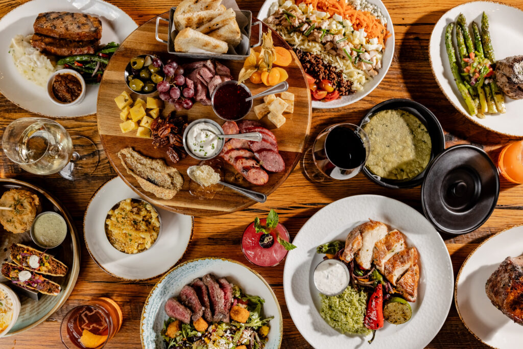 Haywire's spread of dishes such as a meat and cheese board, mac-n-cheese, steak and chicken dishes and more.