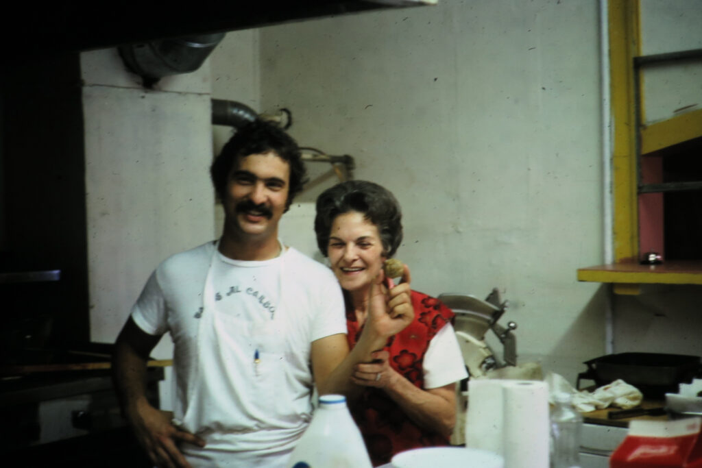 Damien Mandola stands beside his mother. Many of the restaurant’s signature recipes, including spaghetti and meatballs, were inspired by her home cooking. (Photo courtesy of Mandola's)