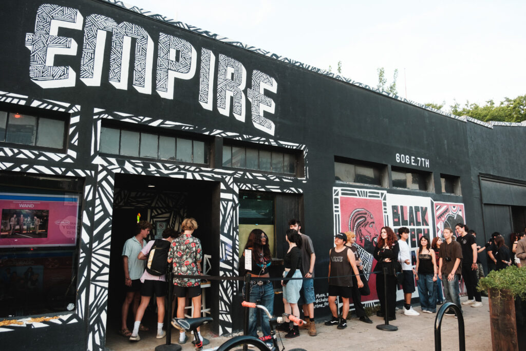 Festivalgoers wait in line outside Empire during Hot Summer Nights 2024 in Austin.