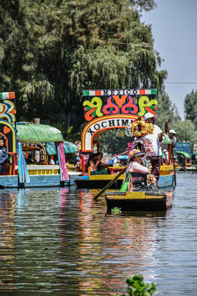 Colorful trajineras float along the ancient canals of Xochimilco, a UNESCO World Heritage Site in southern Mexico City known for its pre-Hispanic origins and festive atmosphere. (Photo by Enzo Renz)