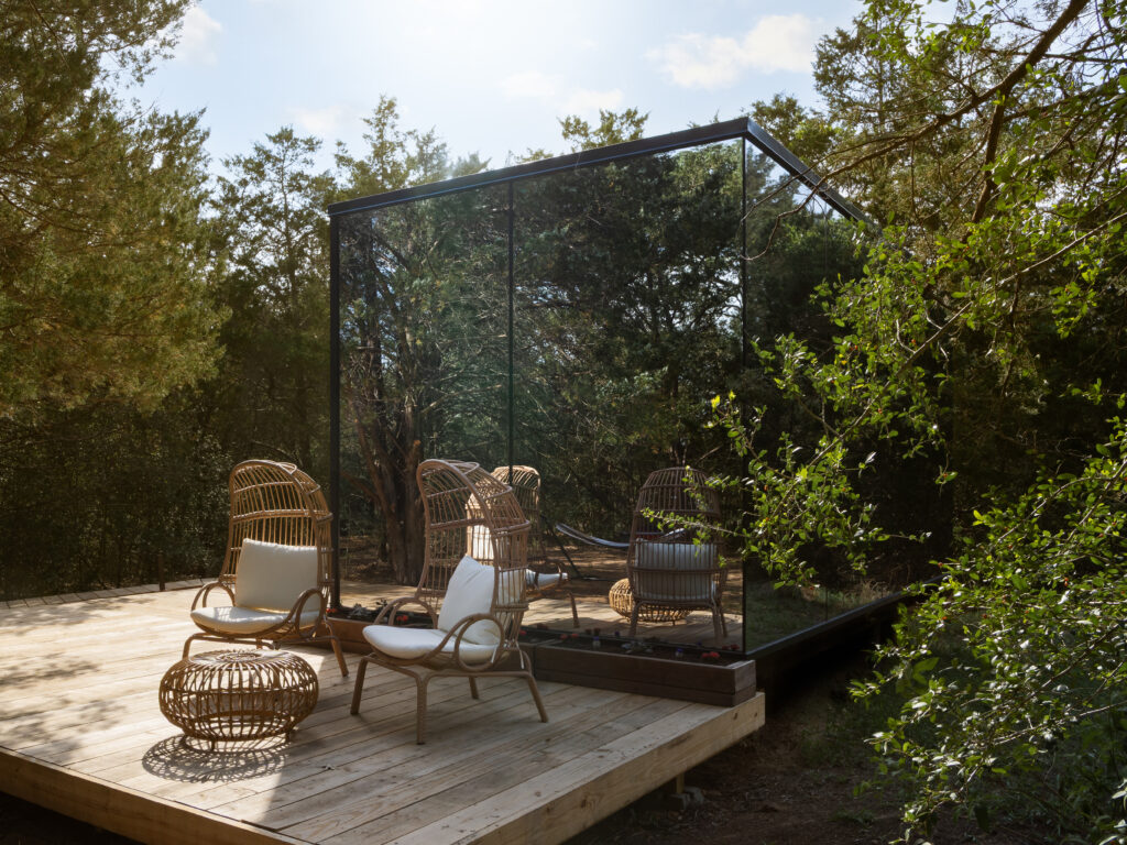 The Bloom cabin's outdoor living area with rattan chairs.