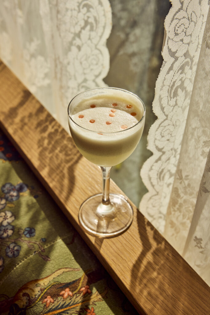 The Arrack & Aura cocktail—made with coconut- and pandan-washed rum, Batavia arrack, palm sugar, calamansi, and drops of curry oil.