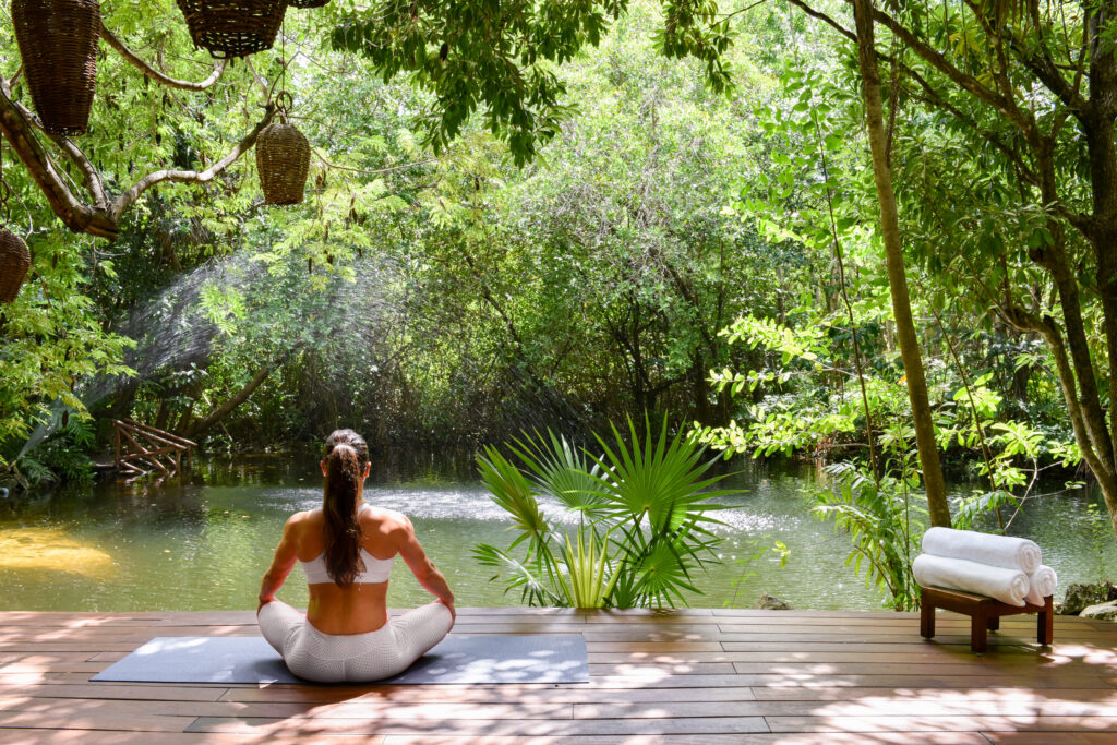 Sitting by the cenote at Sense, A Rosewood Spa