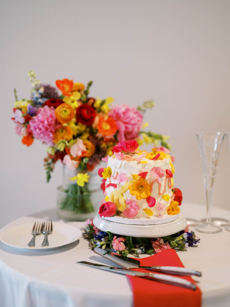 Their floral-themed wedding cake was made by their friend Lauren Frances of Porkchop Screen Printing. (Photo by Katie Knotts)