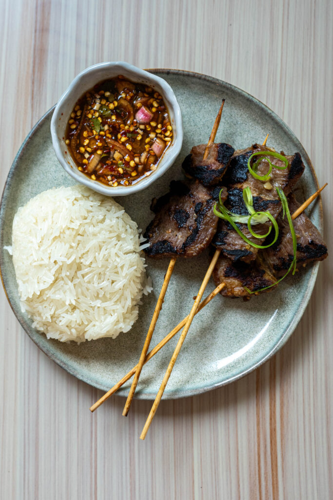 Gati's moo ping, which is marinated pork on sticks served with sticky rice and spicy sauce.