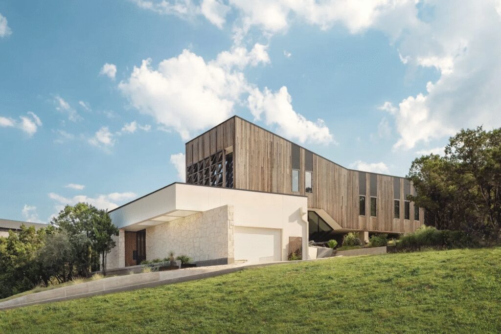 The home at 10700 Superview Drive in Austin offers Hill Country views, expansive outdoor living areas and modern interior finishes.