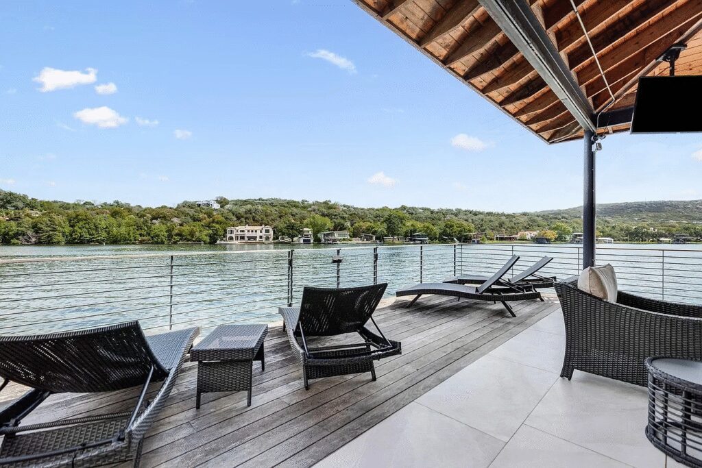 The property includes a newly built 7,410-square-foot main residence, a 3,222-square-foot modern lakefront home, a pool and spa, and a two-story, two-slip boat dock with a rooftop entertaining deck.