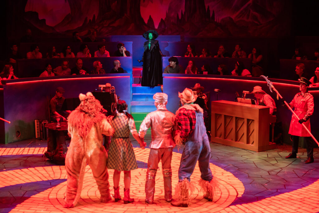 The Wicked Witch enters among audience goers in "The Wizard of Oz" at Zach Theater (photo by Melissa Taylor)