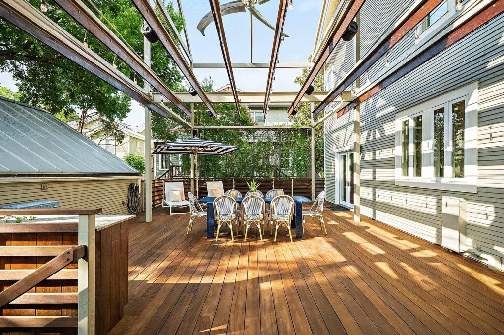 The property includes an expansive wraparound deck with a built-in outdoor kitchen.