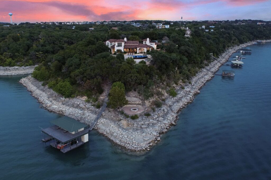 The Sunset Point, a 5-bedroom, 7 full and 2 partial bath Spanish revival estate on a Lake Travis peninsula, spans 7,738 square feet.