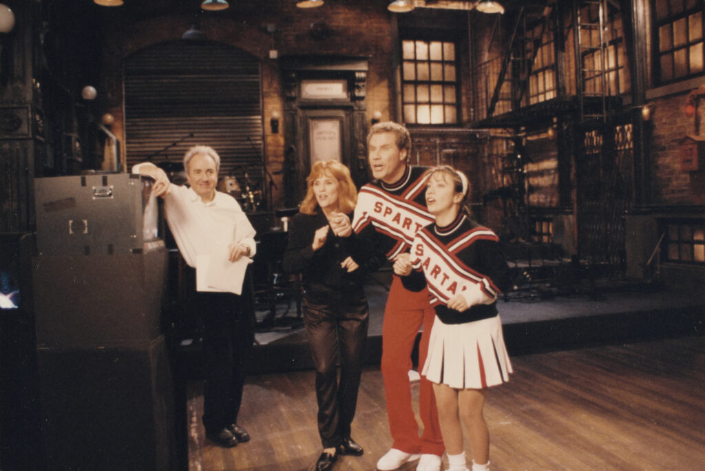 Mary Ellen Matthews, [Lorne Michaels and Madeline Kahn with Will Ferrell and Cheri Oteri as Spartan cheerleaders], 1996. Lorne Michaels Collection. Harry Ransom Center.