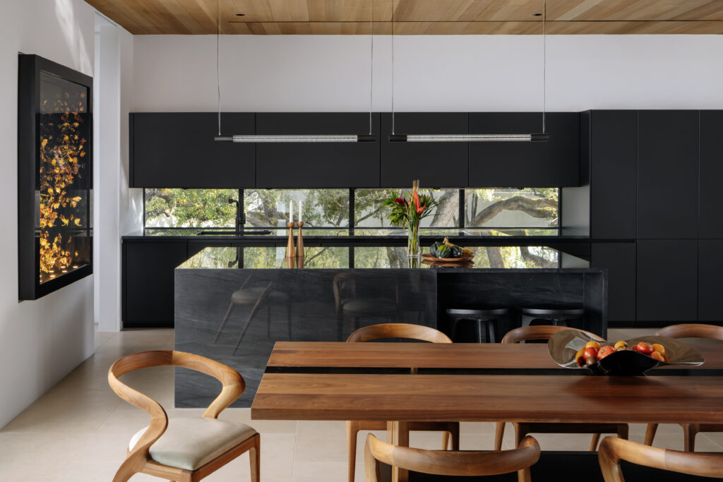 Black finishes and warm wood define the modern kitchen. (Photo by Chase Daniel)