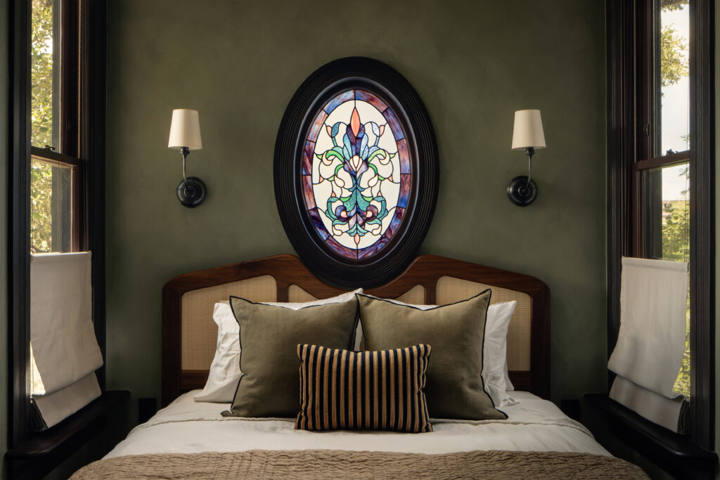 Stained glass brings historic character to the bedroom. (Photo by Chase Daniel)
