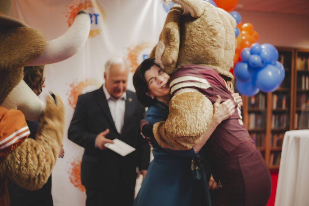 Luci Baines Johnson hugs Texas State University mascot Boko the Bobcat.