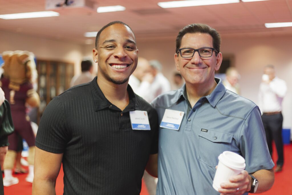 Breakthrough college graduate Jabrell Scott and board of trustees member Steve Martinez.